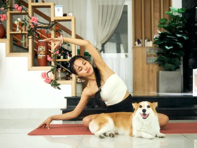 Kun in a gentle seated stretch at Umi Yoga, Da Nang